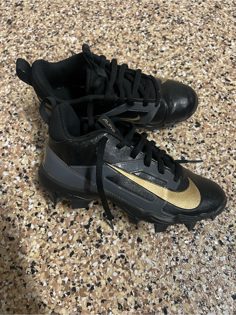 Nike Kids Black and Gold Cleats